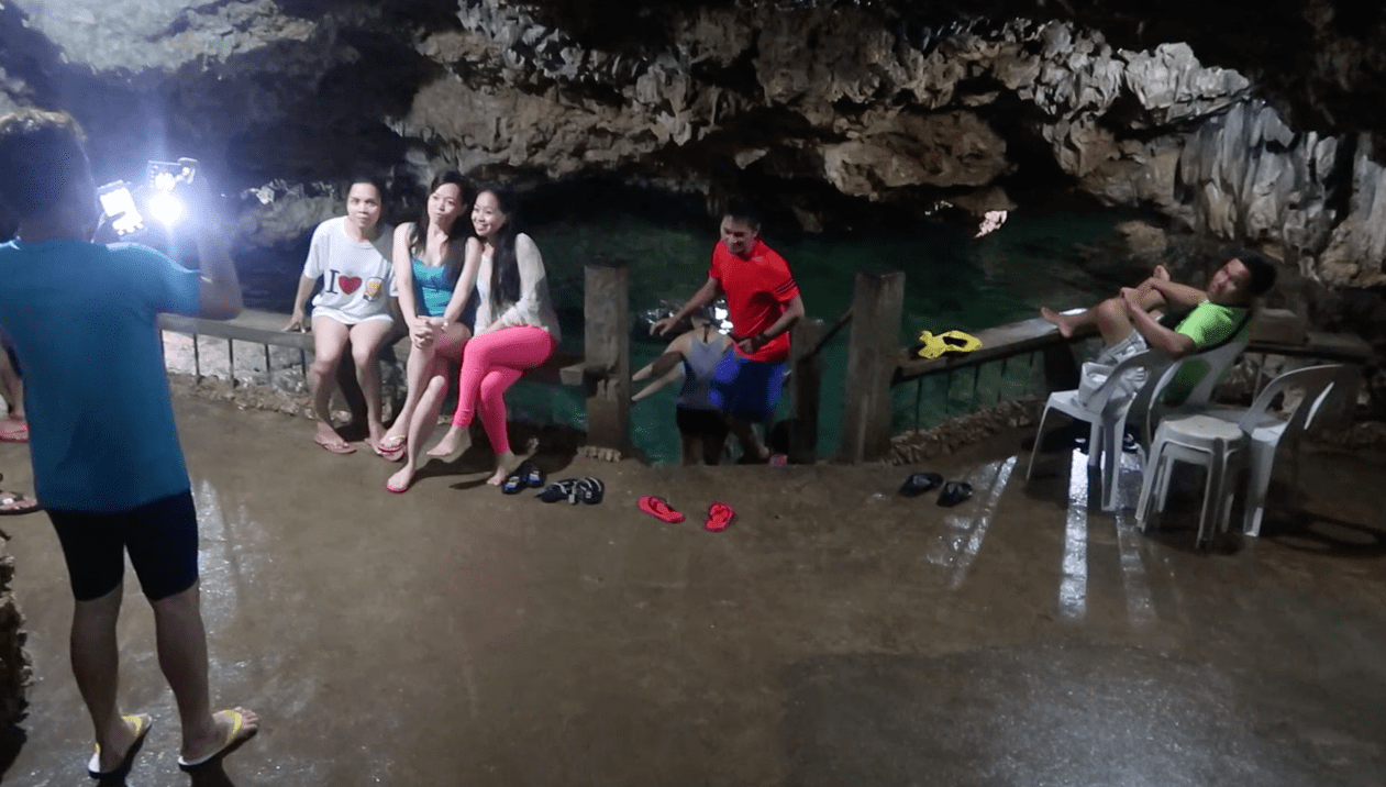 inside the enchanted cave and group of filipinos having fun and taking pictures in bolinao pangasinan philippines